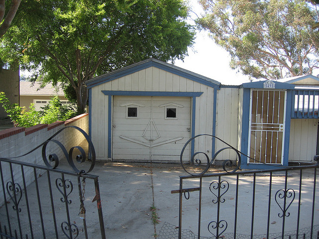 a garage door in the back of a house that appears to be smiling adorably